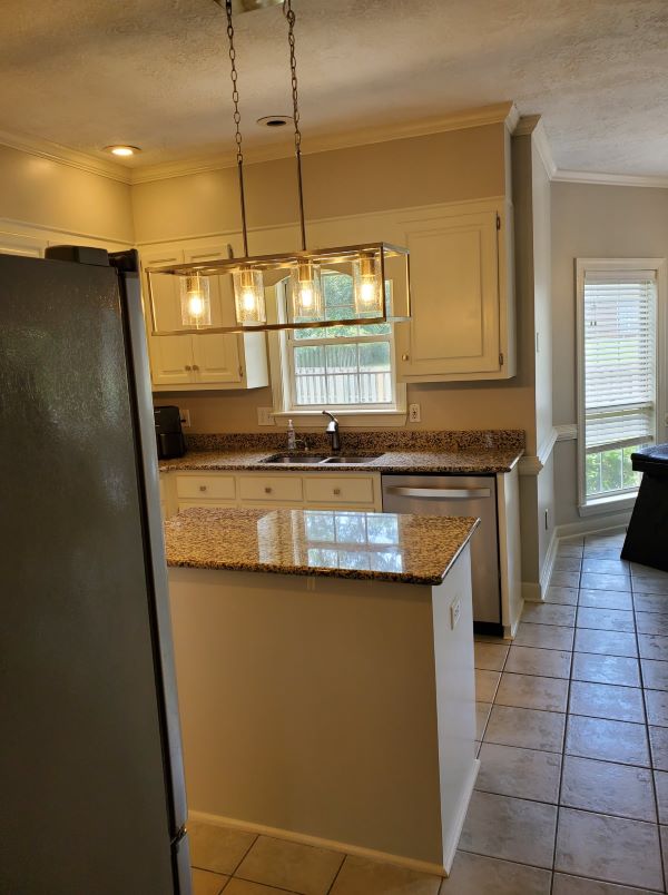 image of kitchen after renovation of Custom Fixture, Painted Cabinets, and countertops