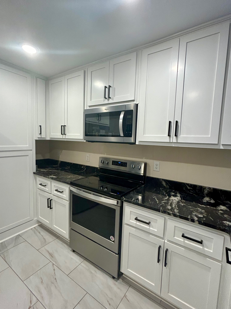 image of kitchen after renovation of Custom Fixture, Painted Cabinets, and countertops